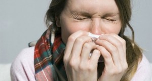 A woman sneezing