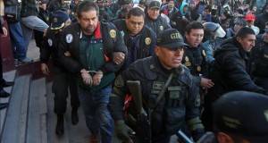 Policías peruanos escoltan al empresario peruano Martín Belaunde Lossio (4-i) este viernes 29 de mayo de 2015, luego de su entrega por parte de las autoridades bolivianas en el puente internacional de Desaguadero, localidad fronteriza entre Bolivia y Perú.
