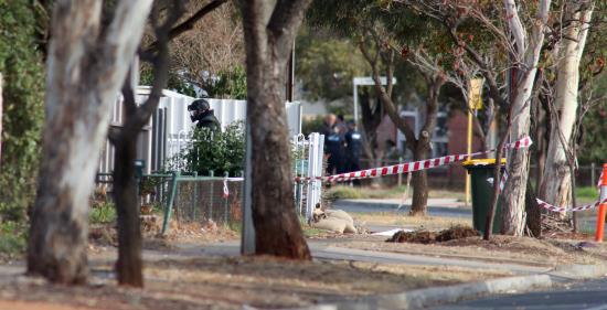 Un artificiero de la policía se acerca a una casa en Davoren Park, Adelaida (Australia), este martes, tras la evacuación de varias viviendas cercanas durante los preparativos para la detonación de un explosivo conocido como "La madre de Satán". La policía supuestamente encontró material para la fabricación de la bomba en la casa durante una redada nocturna, según medios locales. EFE
